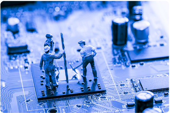 Three toy figurines atop a computer chip on a circuit board